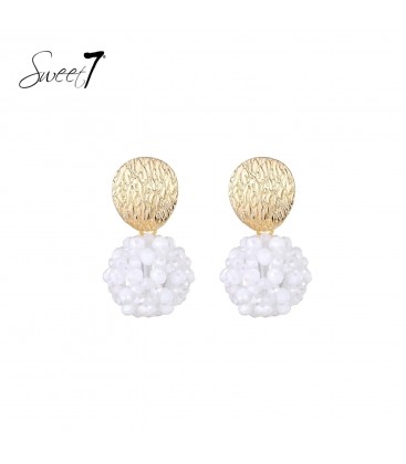 Oorbellen met goudkleurige schijf en witte kralenbol.