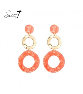 Oorbellen met oranje ronde hanger en goudkleurige schakel