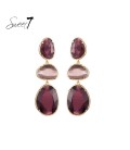 Paarse oorhangers met cat eye stenen en goudkleurige omlijsting